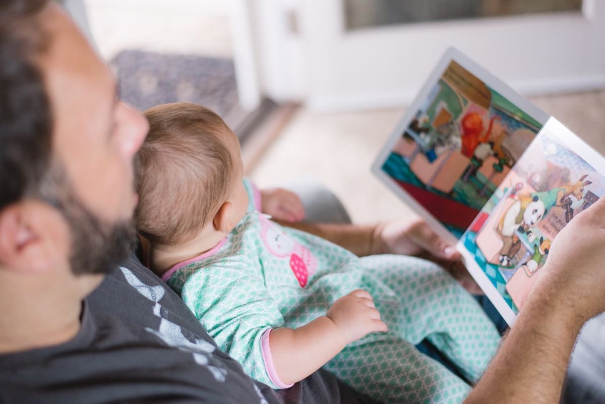 Man reading to a baby.
